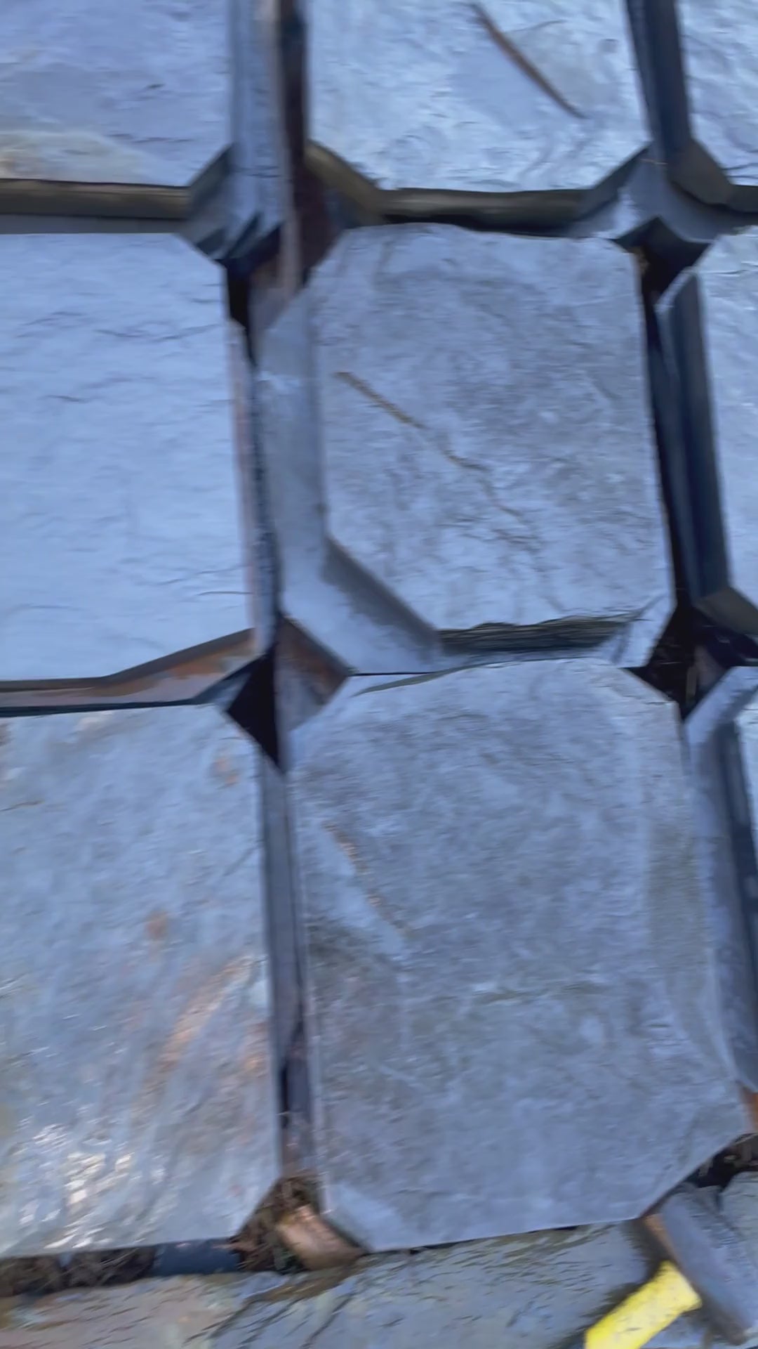 Video of hand-split slate steppingstones with clipped corners stacked on pallets, ready to ship