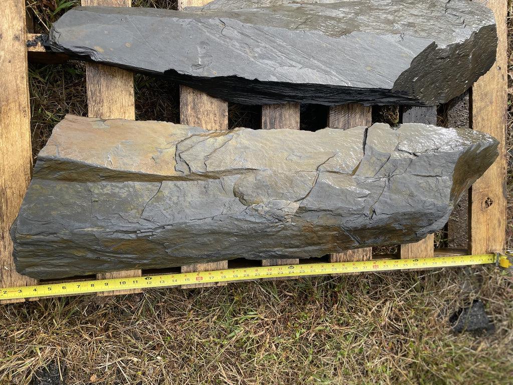 Large slate slabs for a water feature measured with a tape measure