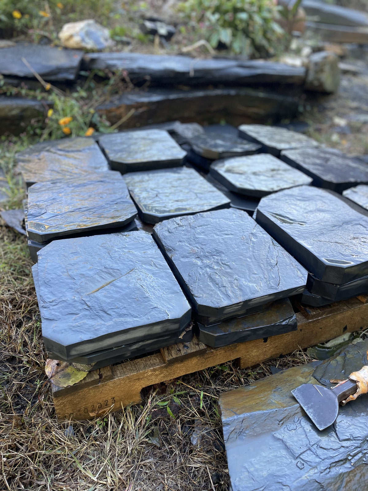Wet hand-split Peach Bottom slate steppingstones showing the natural blue-gray sheen